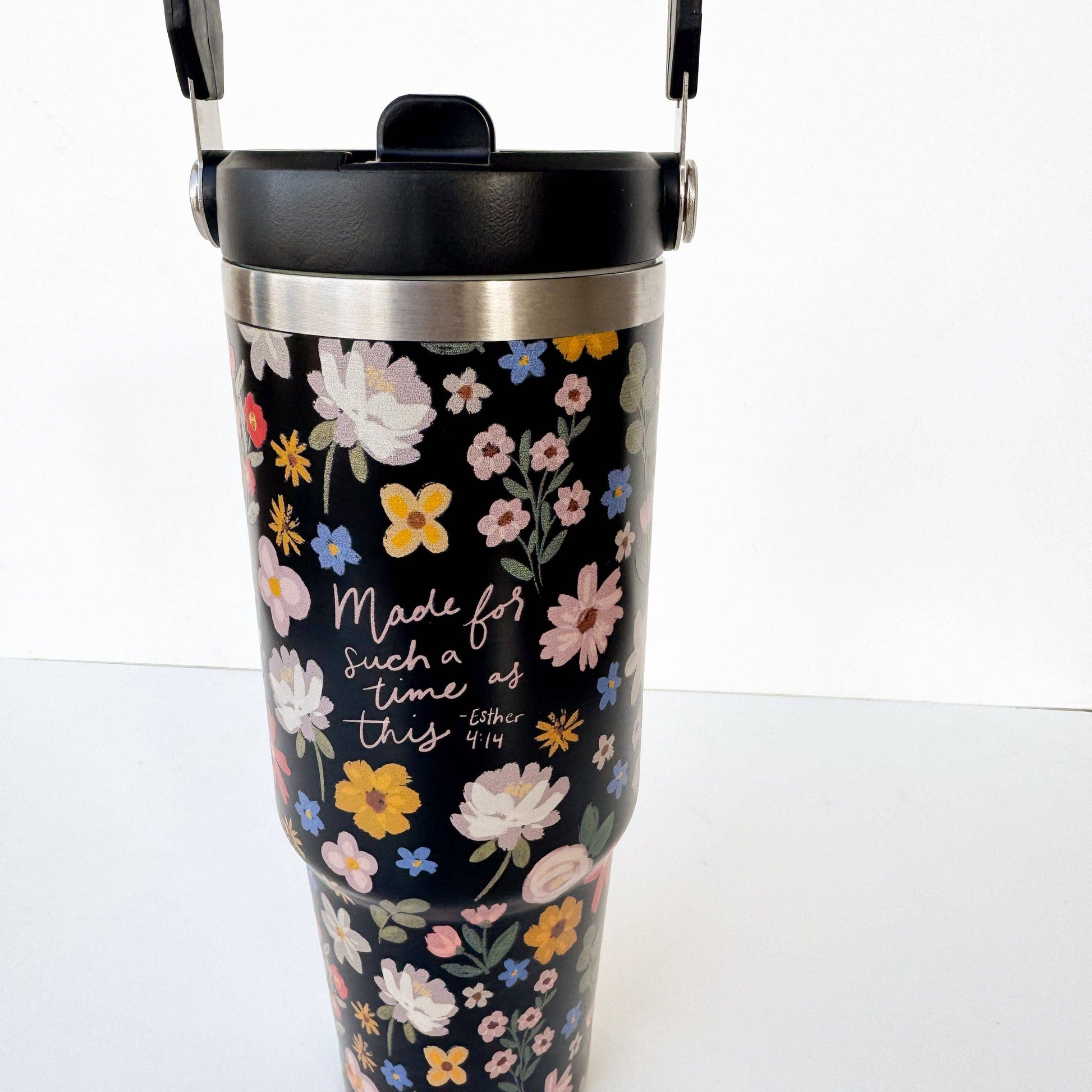 Floral-patterned tumbler with motivational quote on a white background