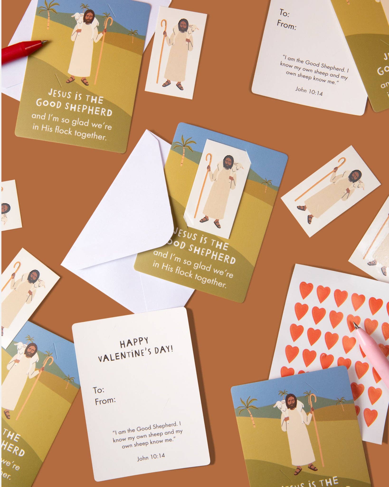 Valentine's Day cards with religious illustrations on a brown surface