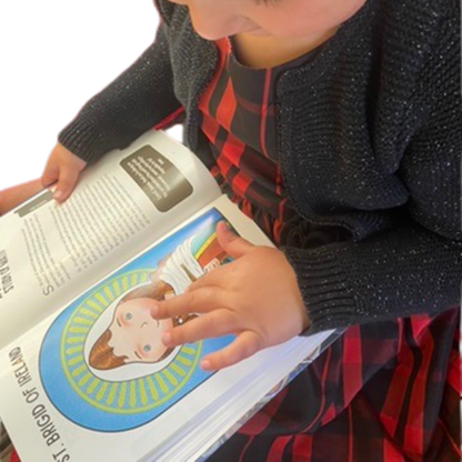 Child holding a book with colorful illustrations