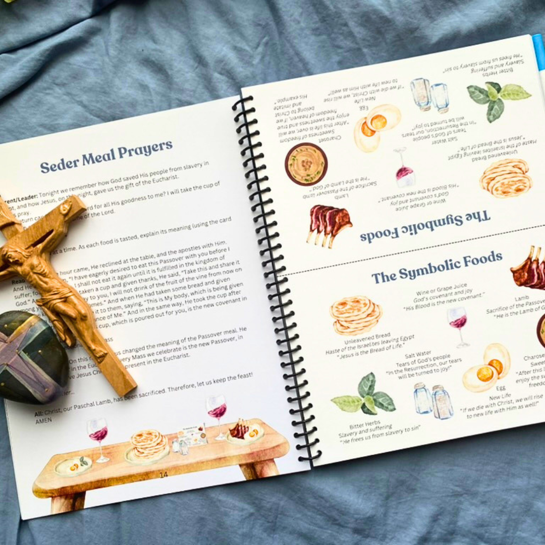 Open book on a blue fabric background with illustrations and text about Seder Meal Prayers and symbolic foods.