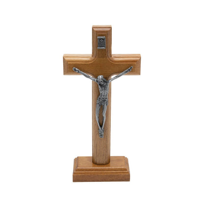 Wooden cross with silver Jesus figure on a white background