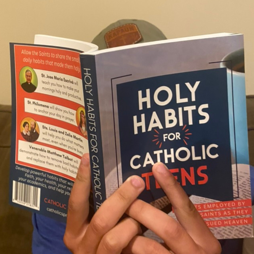 Book titled 'Holy Habits for Catholic Teens' held by a person.