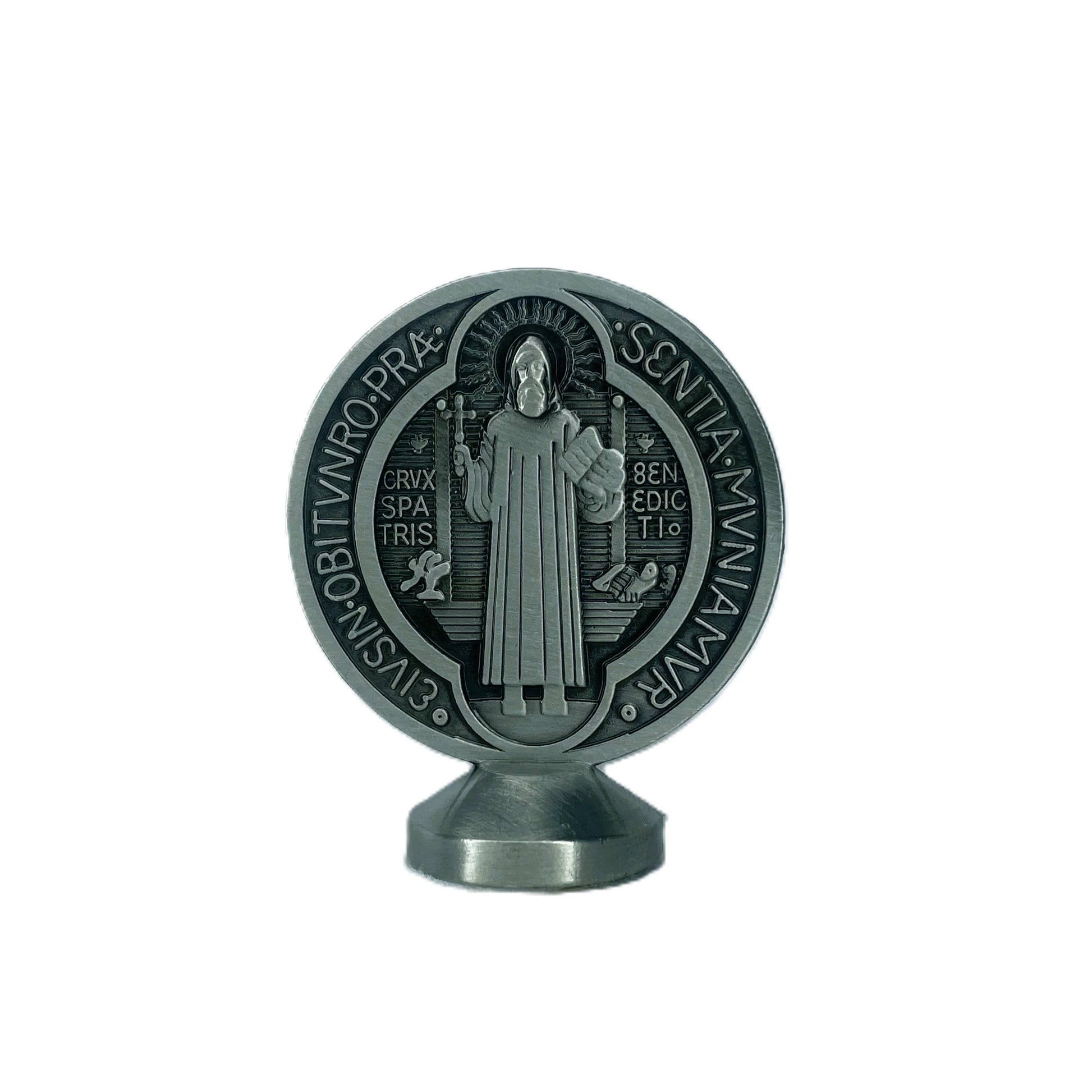 Decorative metal emblem with a religious figure on a white background